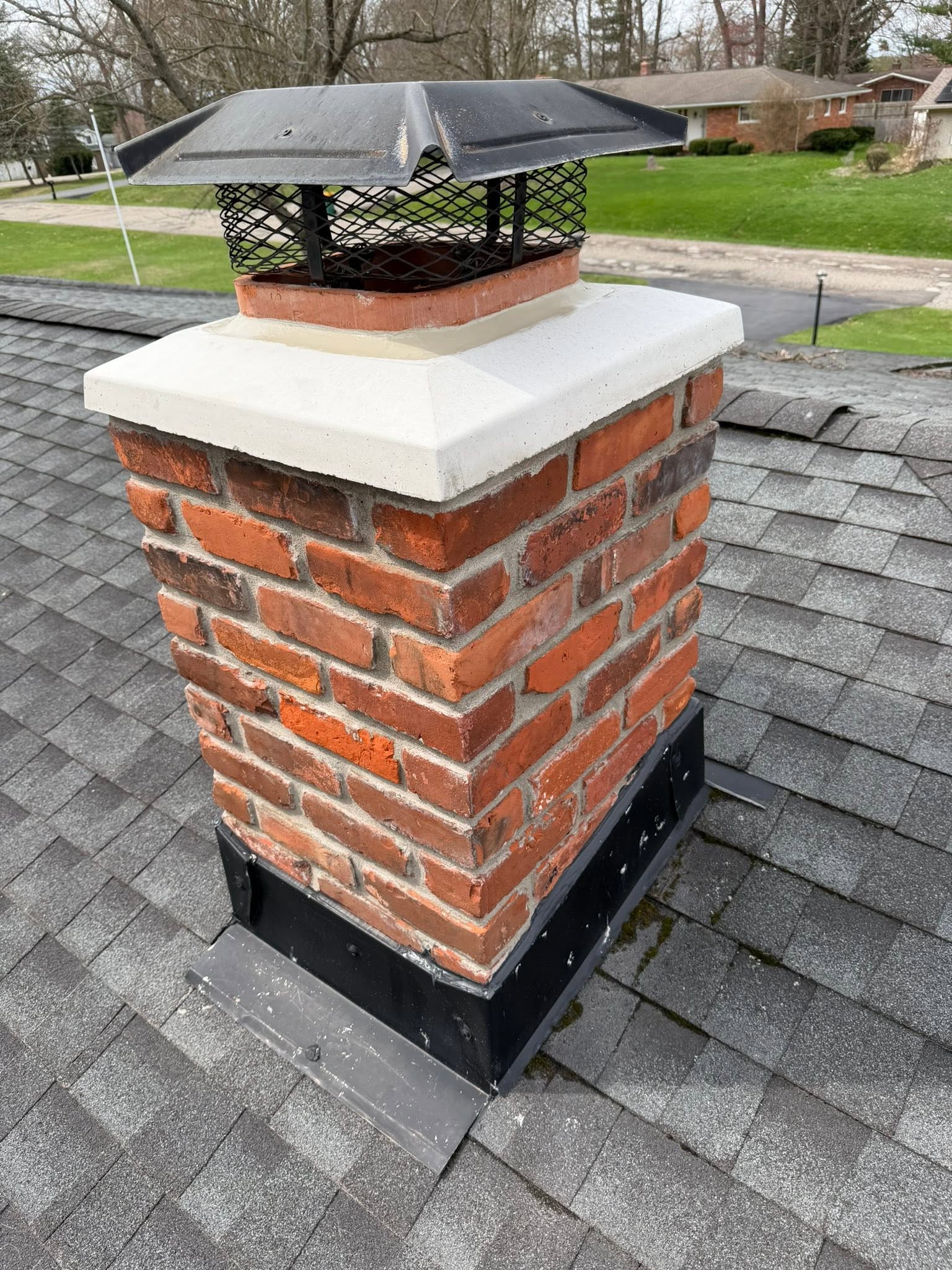 New brick chimney cap and flashing installed by masonry contractor in Genesee County, MI