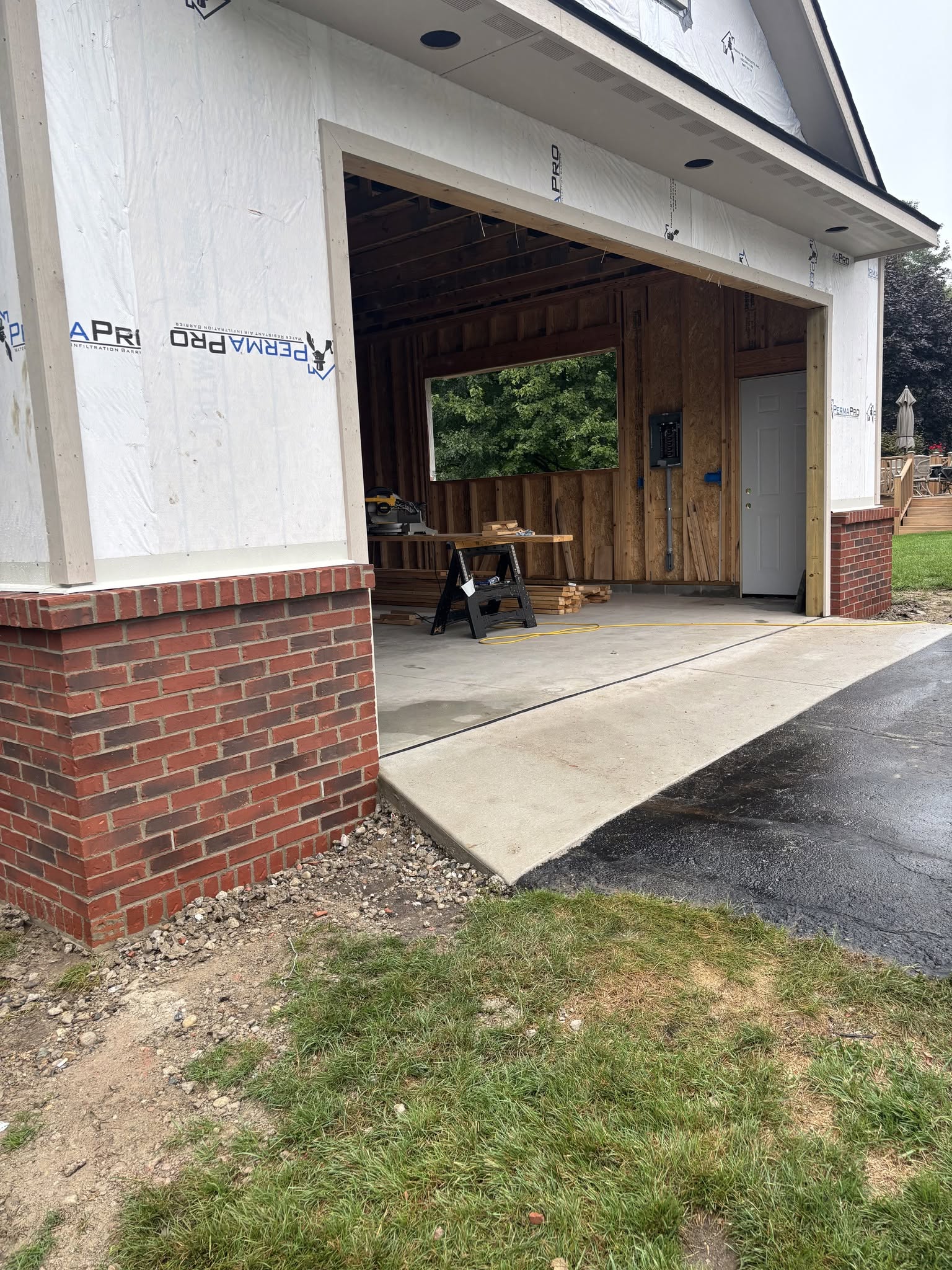 Residential garage framing and brick masonry in progress in Fenton, MI and Genesee County