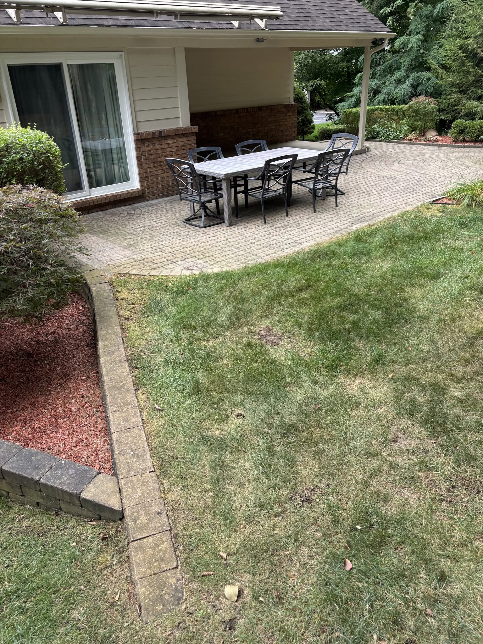 Stone patio hardscape and outdoor living space by Construction company Fenton, MI